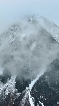 Spectacular view of the huge mount coated with fog. Some snow lies on the mountain in Mount Rainer National Park, Washington State, the USA. Vertical video