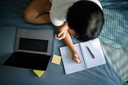 Woman writing on a notebook