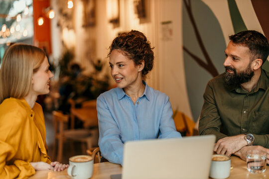Business people meeting in cafe discussing work project