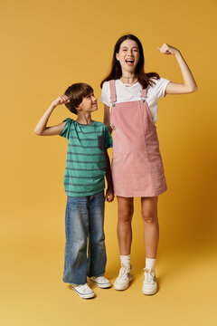 A young mother and her son share a playful moment in a studio, showcasing their bond.
