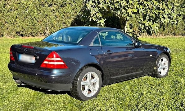 Mercedes-Benz SLK convertible sports car parked on grass