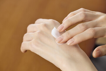 Fototapeta premium Hands Applying Moisturizing Cream to Skin