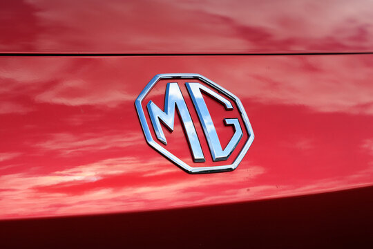 Koprivnice, Czech Republic, Czechia - 31 May, 2026: MG, Morris Garages - logo and brand of car and auto manufacturer. Detail of red vehicle. Shallow focus.	