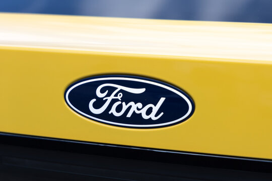 Koprivnice, Czech Republic, Czechia - 31 May, 2026: Ford - logo and brand of car and auto manufacturer. Detail of yellow vehicle. Shallow focus.	