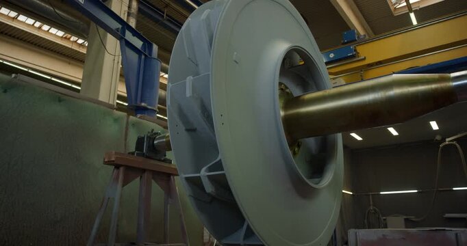 Close up of a large industrial impeller rotor being inspected or prepared in a manufacturing plant