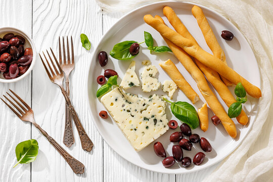 Italian blue cheese platter with grissini and olives
