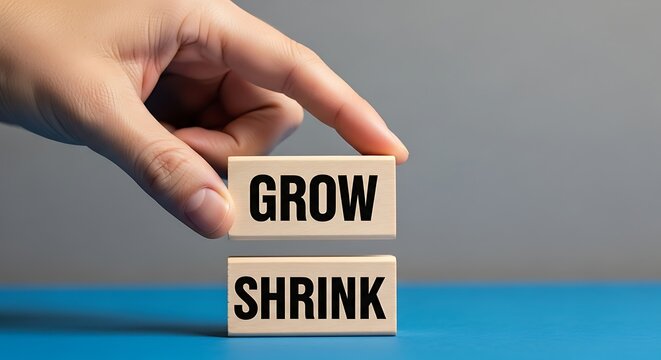 Business growth and shrink concept on wooden blocks, hand choosing grow over shrink, financial scaling and economic development metaphor