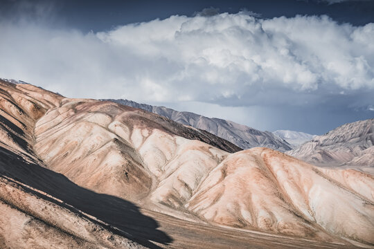 Rocky mountain slopes in the Pamir Mountains in Tajikistan, a minimalist landscape and rocky hills in sunny weather