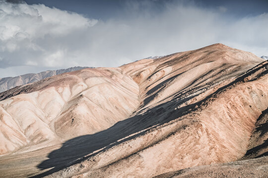 Rocky mountain slopes in the Pamir Mountains in Tajikistan, a minimalist landscape and rocky hills in sunny weather