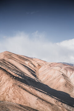 Rocky mountain slopes in the Pamir Mountains in Tajikistan, a minimalist landscape and rocky hills in sunny weather