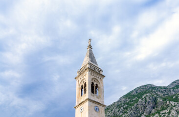 Fototapeta premium Ancient mediterranean campanile and mountain landscape, stone church bell tower
