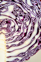 Obraz premium A close-up shot of a red cabbage on a white surface, great for use in food-related contexts vertical frame