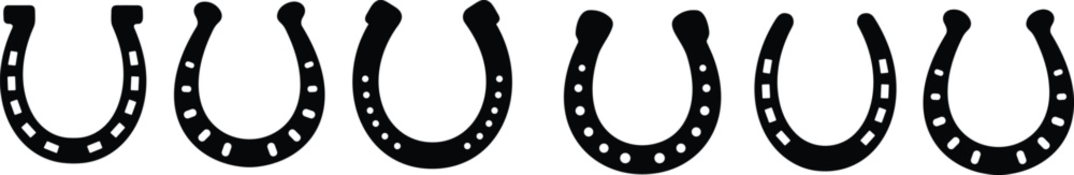 Black and white horseshoe collection a row of traditional metal horse shoes isolated on white