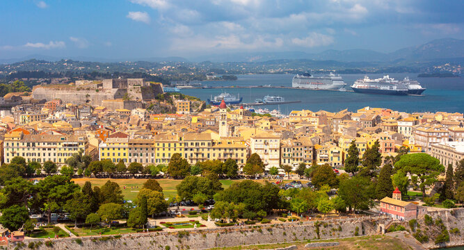 Panoramic view of Corfu Old Town with historic fortifications, harbor and cruise ships along the Ionian coast.