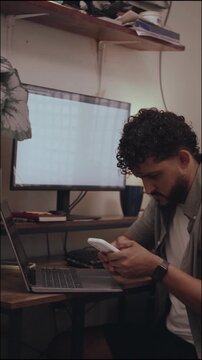 Hispanic entrepreneur working on laptop in home office