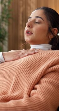 Breathing, tapping and eft with woman in home for somatic technique, calm and self regulation. Acupressure, mental health and stress relief with person with anxiety in living room of apartment