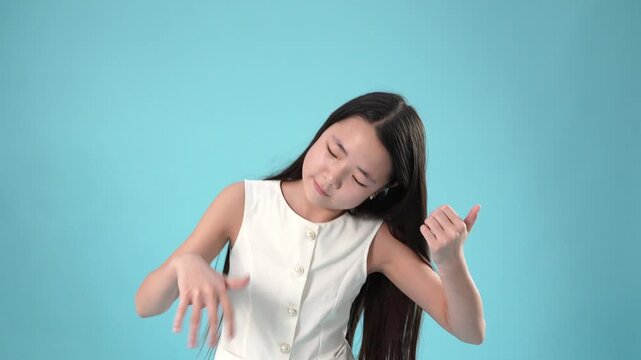 Young asian girl pretending to play the drums or synthesizer