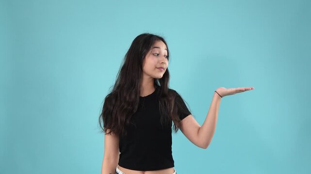Young woman pointing at blank space and showing like gesture