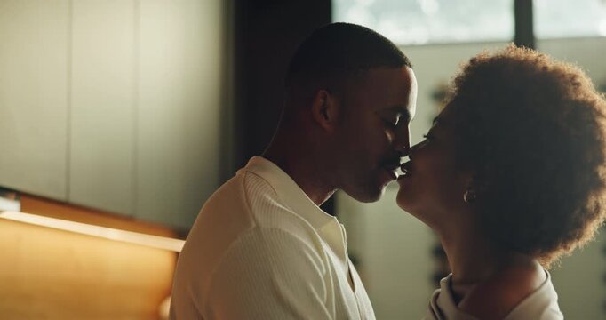 Kissing, moment and love with black couple in kitchen of home together for bonding or security. Affection, hugging and laughing with happy people in apartment for connection, morning or trust