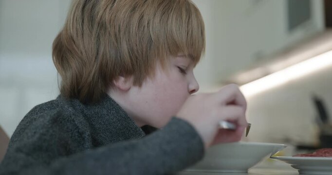 Kid Boy Eat Fried Potato. Eating Breakfast Lunch in Kitchen. 4K 10-bit