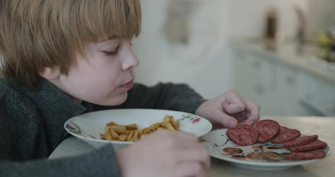 Kid Boy Eat Fried Potato. Eating Breakfast Lunch in Kitchen. 4K 10-bit