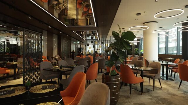 Chic hotel restaurant and lounge area with modern orange chairs