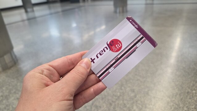 MADRID, SPAIN - JUNE, 22, 2026. Close up of renfe cercanias commuter travel card held in hand in madrid for travel banner and public transport background