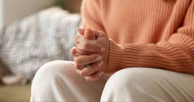 Anxiety, worry and hands of woman on sofa for overthinking, nervous and doubt for emotional concern. Home, stimming and person with gesture for overwhelmed, unsure and anxious for mental health