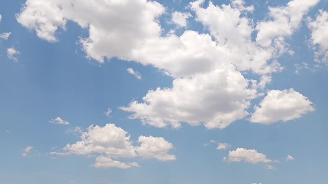 Beautiful white clouds moving in the cheerful sky at midday