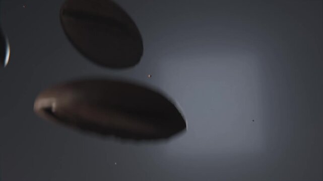 Releasing off-frame rim sending coffee beans tumbling across gray backdrop, for close-up capture