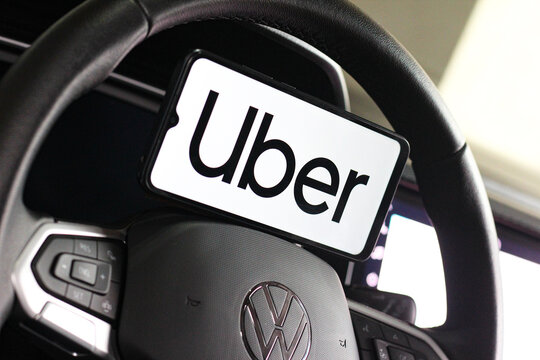 In this photo illustration, the Uber logo is seen displayed on a smartphone screen.