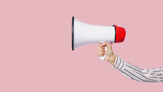 hand holding a megaphone a isolated free color background.