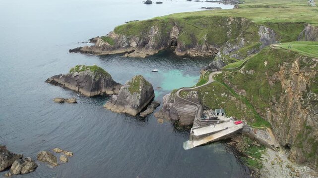 Drone aerial 4k ultra high definition of stunning view of dunquin pier, a famous harbor on the slea head drive. Drone footage capturing the dramatic cliffs and turquoise waters. Dingle Peninsula Irela