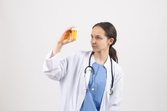 Female doctor holding medicine bottle in studio for stock photography web use