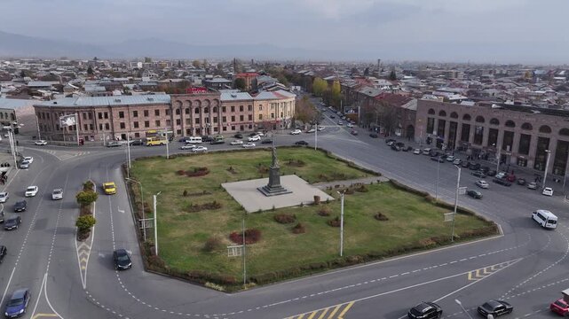 Aerial drone shot of the beautiful city of Gyumri in Armenia, showcasing its historic architecture, busy city squares, streets, and the famous landmark Holy Saviour's Church during autumn.

