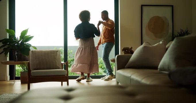 Couple, dance and holding hands in lounge, house and bonding with partner on anniversary or spinning. Black people, home and forehead touch with spouse, rhythm and happy for relationship milestone