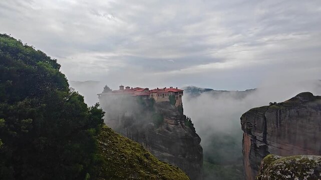 Aerial view of Meteora monasteries and the rock formations in the mountains of Greece near Kalabaka city. Monastery of the Holy Trinity. Unesco world heritage site. Drone Video