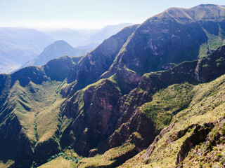 Breathtaking vista of the majestic Andean mountain range in Peru, featuring vast, green valleys and rugged peaks under a clear, expansive sky, highlighting the stunning natural beauty © Martin