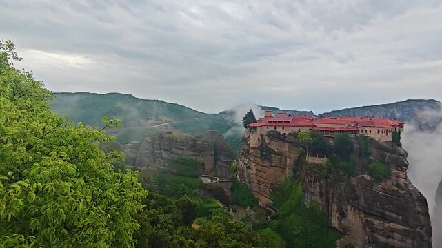 Aerial view of Meteora monasteries and the rock formations in the mountains of Greece near Kalabaka city. Monastery of the Holy Trinity. Unesco world heritage site. Drone Video