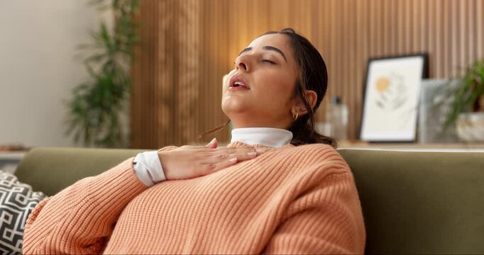 Anxiety, pressure or woman with chest pain on sofa from panic attack, shortness of breath or fear. Respiratory illness, person or stress for asthma in home for discomfort, heart palpitations or worry
