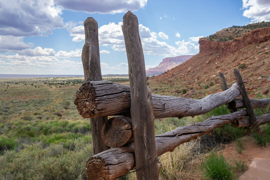 Western landscape with rustic split rail fence and scenic buttes in the background