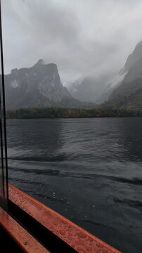 Boat ride on K&ouml;nigssee surrounded by dramatic alpine mountains in Bavaria, Germany