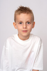 Fototapeta premium Portrait of a cute preteen boy in white t-shirt