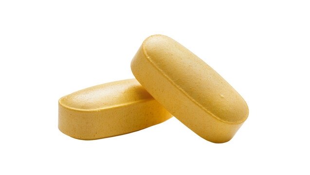 Isolated two textured yellow orange oblong vitamin pills or dietary supplements close-up.