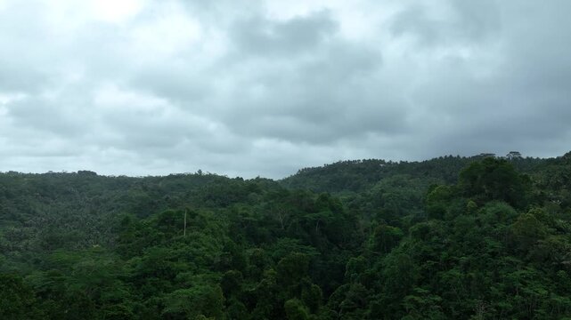 Aerial view of a dense layer of grey storm clouds filling the sky above Pangandaran Regency, West Java, Indonesia.