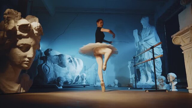 Professional ballerina performing whirling in dance studio, graceful dancer. Attractive young woman rehearsing classical choreography in rehearsal hall in night, preparing to performance on stage