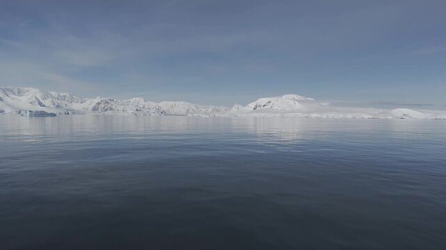 Aerial View of Sunny Antarctic Peninsula with Icebergs 4K