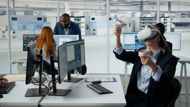 Woman in manufacturing lab using VR goggles to design energy efficient semiconductors, Female engineer using virtual reality simulation to upgrade microchip hardware production, camera A.