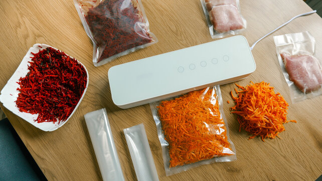 Preparing food for vacuum sealing with fresh ingredients and a modern sealing machine