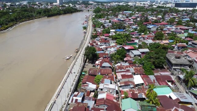 Drone aerial footage of Davao, Philippines featuring dense urban housing, residential neighborhoods, city infrastructure, bridge and compact urban development captured from above.